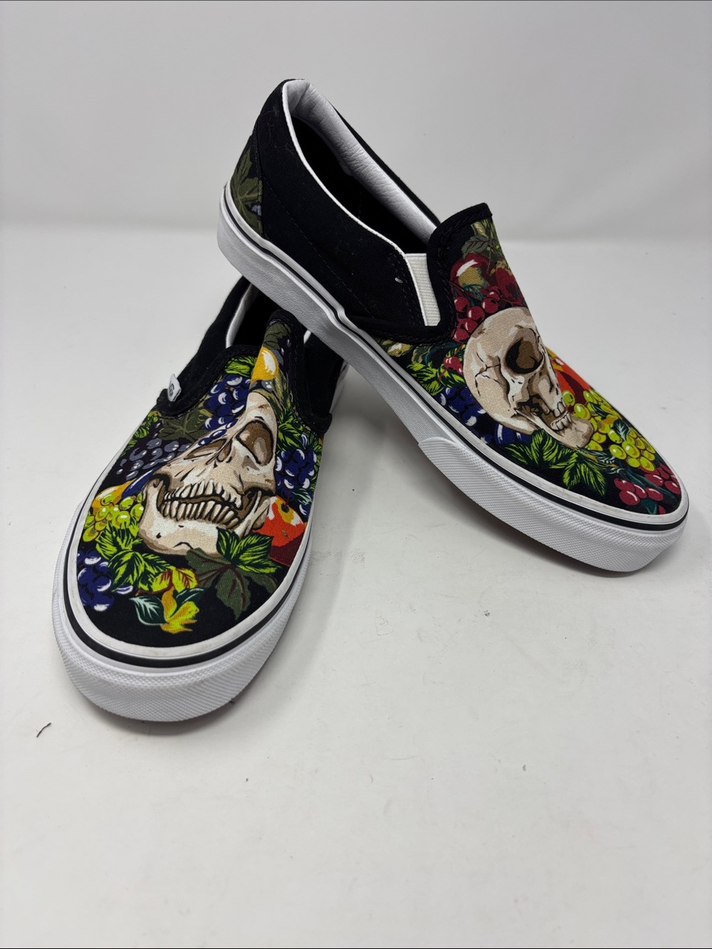 Vans | 9 Slip-On Sneakers in Black with Multicolor Floral Skull Print
